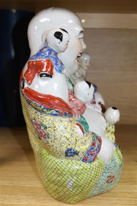 A Chinese enamelled porcelain figure of Budai with attendants height 30cm